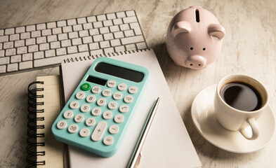 Notepad, piggy bank, keyboard and calculator