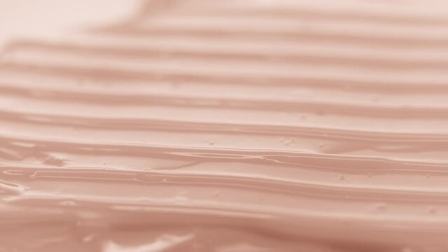 Crane macro shot of beige moisturizing cream with yeast extract and vitamin B5 wave texture | Moisturizing cream commercial