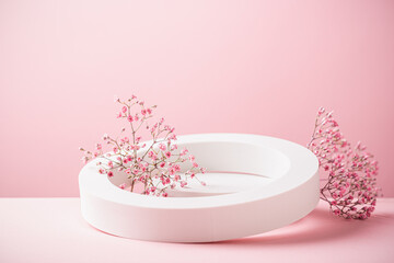 Obraz na płótnie Canvas Abstract empty white podium with flowers on pink background. Mock up stand for product presentation. Minimal concept. Advertising template