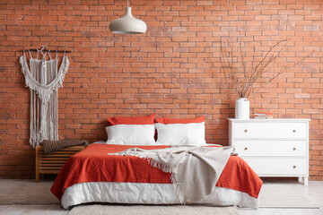 Interior of stylish bedroom with drawers and big bed