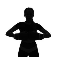 Silhouette of sporty young woman in boxing gloves on white background