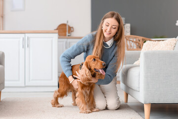 Young woman with red cocker spaniel in kitchen