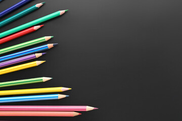Set of colorful pencils on black background