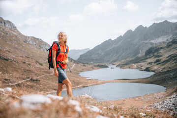 Naklejka na ściany i meble Young woman is enjoying hiking on the mountains of austria