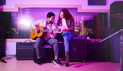 Black man, woman and songwriting with guitar, studio and night with paper for creative lyrics,...