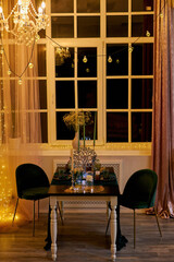 Romantic dinner table setting with festive lights
