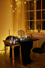Romantic dinner table setting with festive lights