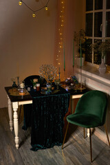 Romantic dinner table setting with festive lights