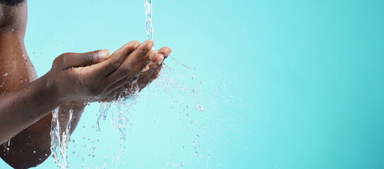 Water, black man and cleaning hands with mockup space, wash face and skincare isolated on blue...