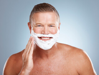 Shaving cream, happy and portrait of old man in studio for skincare, grooming and beauty on grey background. Face, foam and hair removal for mature model smile for skin, beard and shampoo product