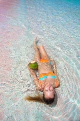 Girl On Ombre Pink Sand & Turquoise Water Beach Lays In Water