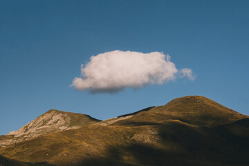 Big cloud on top of mountain peaks during sunset, Pyrenees