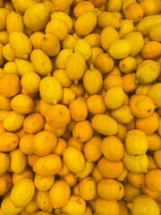 lots of yellow ripe lemons vitamins taste fruit for eating as background