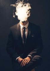 Businessman, suit and smoke in dark studio for corporate fashion, mafia aesthetic and success. Young model, man and smoking to hide face in secret for crime boss, vintage hand by black background © Emily/peopleimages.com