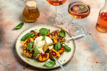 Burrata cheese and grilled peaches with rose wine. top view. place for text