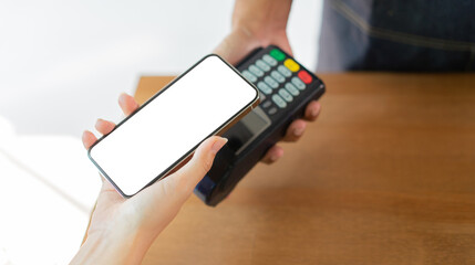 close up customer hand using smartphone (isolated blank display) for paying bill by using payment...