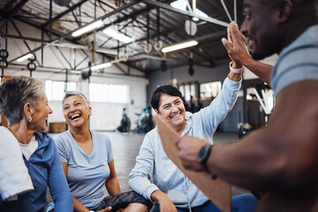 High five, group or team of fitness senior women at the gym after exercise, workout or training with personal trainer. Elderly, old and people happy, smile and excited for teamwork and motivation