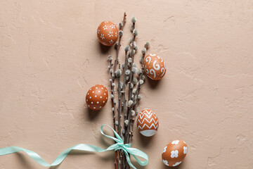 Composition with willow branches and painted Easter eggs on color background
