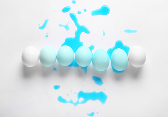 Beautiful Easter eggs and spilled natural dye on white background