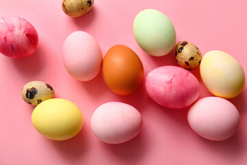Natural and painted Easter eggs on pink background