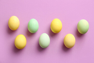 Painted Easter eggs on lilac background