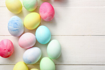 Fototapeta na wymiar Painted Easter eggs on white wooden background, closeup