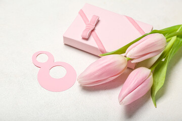 Beautiful tulip flowers, number 8 and gift for Women's Day celebration on white background