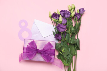 Beautiful eustoma flowers, number 8, envelope and gift for Women's Day celebration on pink background