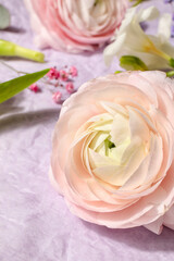Beautiful spring flowers on crumpled paper background, closeup