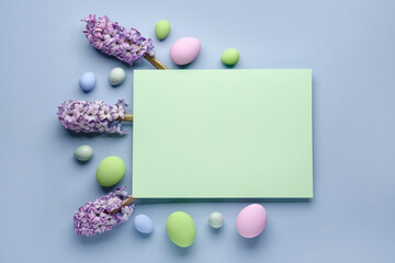 Composition with blank card, beautiful hyacinth flowers and Easter eggs on color background