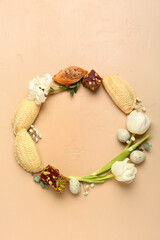 Frame made of flowers, eggs and treats on beige background. Novruz Bayram celebration