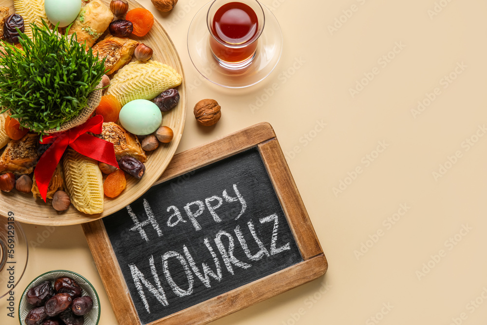 Wall mural chalkboard with text happy nowruz, treats, glass of tea and grass on beige background