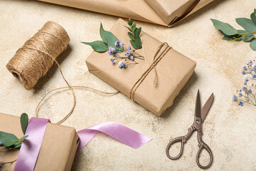 Composition with gift boxes, gypsophila flowers, rope and scissors on light background. Women's Day celebration