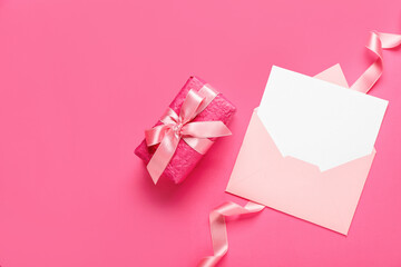 Envelope with blank card and gift box on pink background. Hello spring
