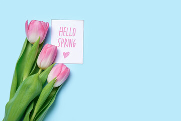 Beautiful tulip flowers and card with text HELLO SPRING on color background