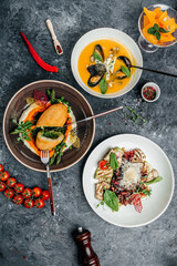 Set of dishes from vegetables and meat on the table. food background, top view. place for text
