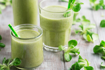 Detox Diet Concept: Green Spinach Smoothie on White Wooden Table.