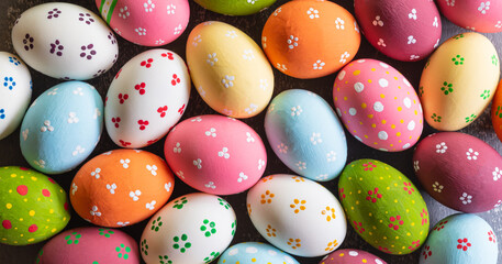 Fototapeta na wymiar Happy easter! Colourful of Easter eggs in on gray wooden background.