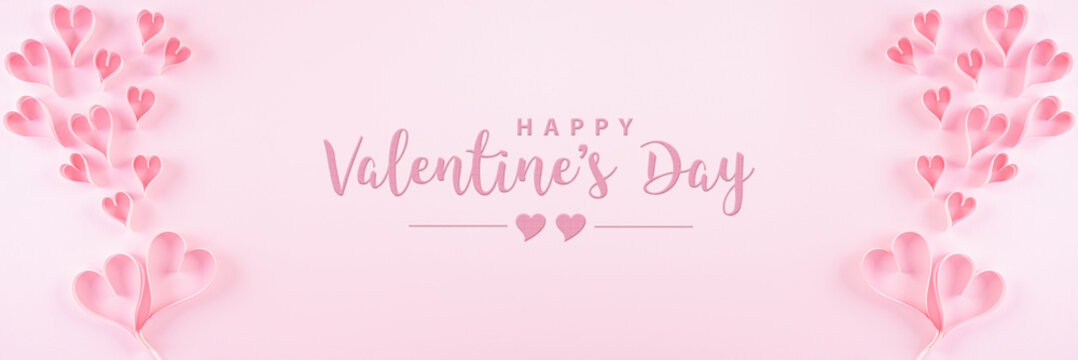 Pink paper hearts and the text on pastel paper background. Love and Valentine's day concept.