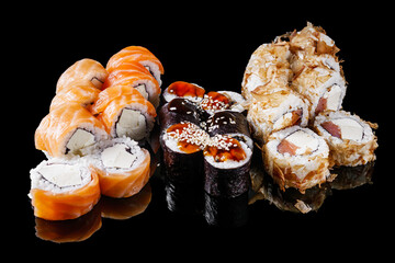 sushi roll with cream cheese salmon shrimp cucumber avocado set on a black mirror background