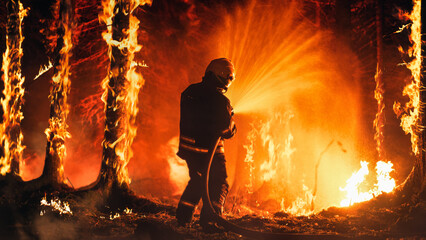 Professional Firefighter Extinguishing Large, High-Priority Part of the Forest Fire. Highly Skilled...
