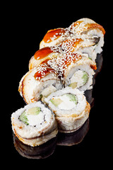 sushi roll with avocado cucumber cream cheese eel unagi on a black mirror background