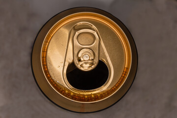 Top view of open beer can on a blurred background