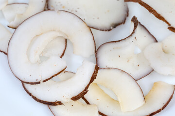 Round dried coconut pulp slices, close-up in selective fovus