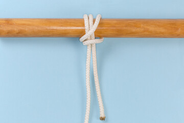 Tightened rope knot Pile hitch tied around a wooden pole