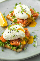 poached egg on toast with salmon, lettuce salad, Delicious breakfast or snack, Clean eating, dieting, vegan food concept. top view