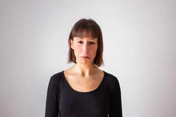 Portrait of a girl on white background. Brown short hair girl. sad girl about to cry.	