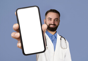 Medical Ad. Smiling Male Physician Showing Big Blank Smartphone At Camera