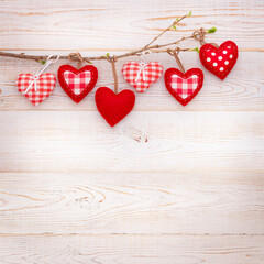 Valentine day love background. Hearts hanging on branch of tree