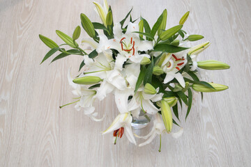 Bouquet of white lilies in a vase top view